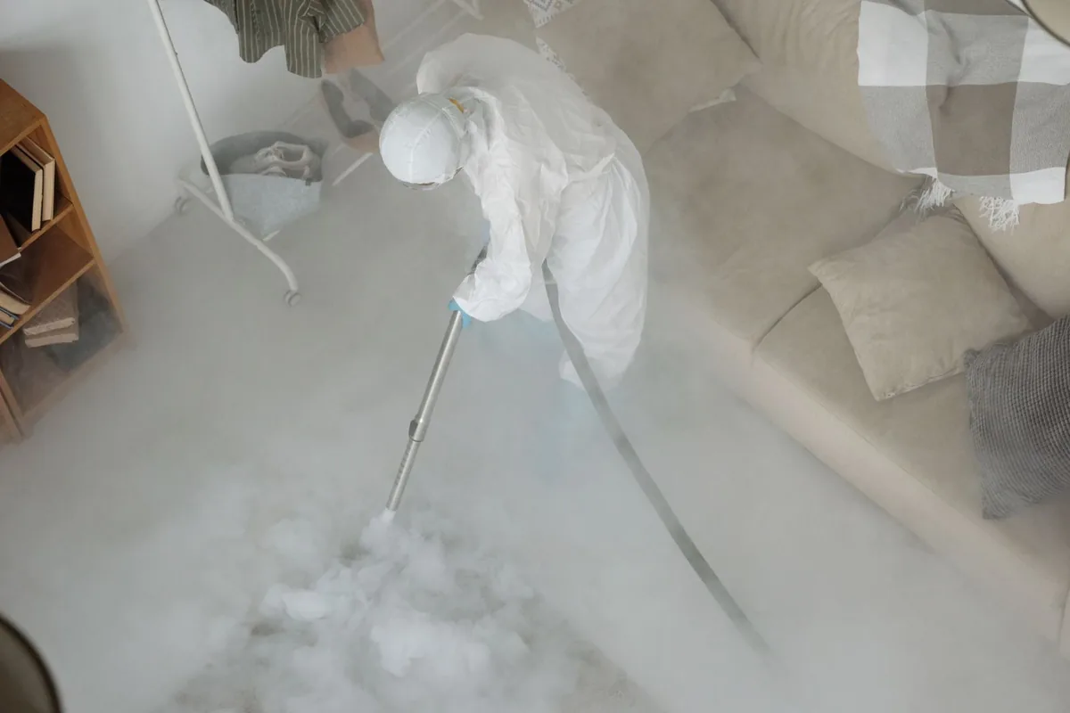 Biohazard cleanup technician in protective equipment, Lower Grand Lagoon, FL